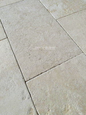 Installing antique French limestone in a running bond pattern around the patio deck and outdoor kitchen is beautiful.