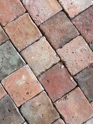 Rich patina and antique edge detail define a quality antique French reclaimed terra cotta tile cobblestone.