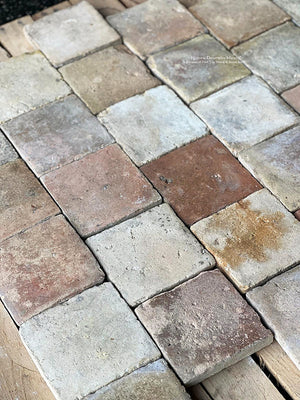 Antique French reclaimed terra cotta tile cobblestones show history with their 150-year old surface patina.