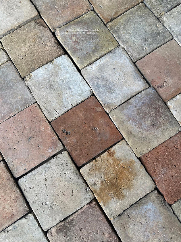 The mixed color palette of this French reclaimed terra cotta tile cobblestone is one of clay, earth, chalk white and blush colors.