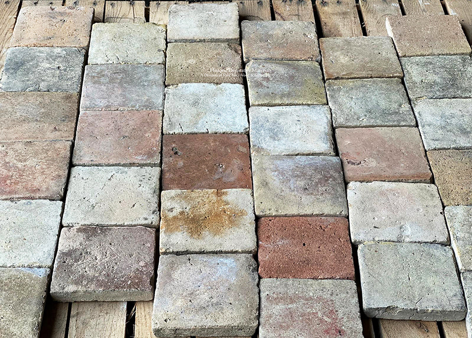 The surface patina and edge detail of reclaimed French terra cotta tile cobblestone are gorgeous.
