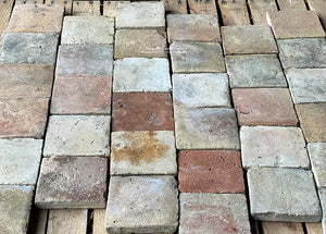 The surface patina and edge detail of reclaimed French terra cotta tile cobblestone are gorgeous.