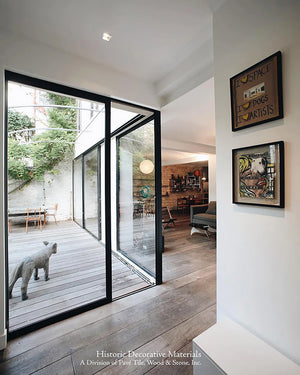 The classic warm and cool contrast exists when installing aged French oak floors and floor to ceiling windows.