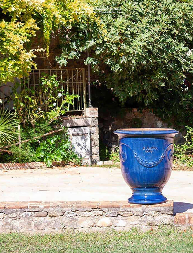 Glazed French blue pottery from Anduze Provence adds French elegance to garden paths and walkways.