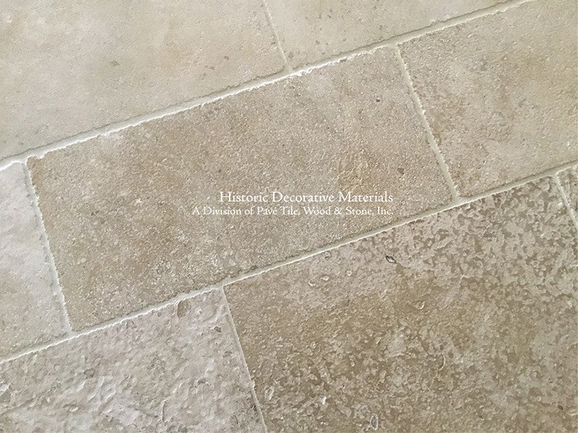 Warm ivory antique French limestone floors are soft neutrals for beautiful kitchens.