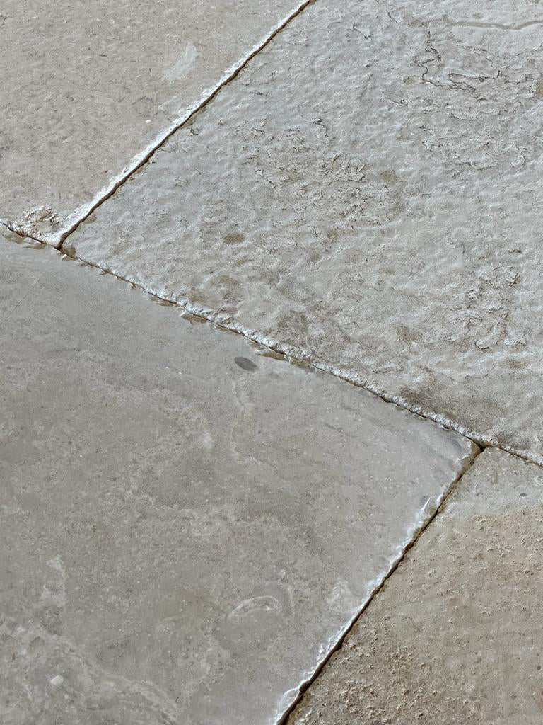 Hand-chiseled patina is a hallmark of antique French limestone flooring.