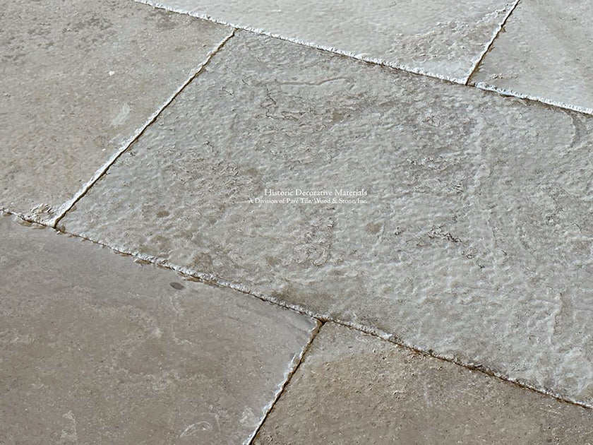 Gray and brown antique French limestone creates a spectacular kitchen floor.