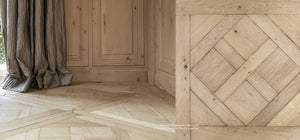 The natural oak colors of a hand-finished aged French oak floor has been a Parisian design feature  since the 19th century.