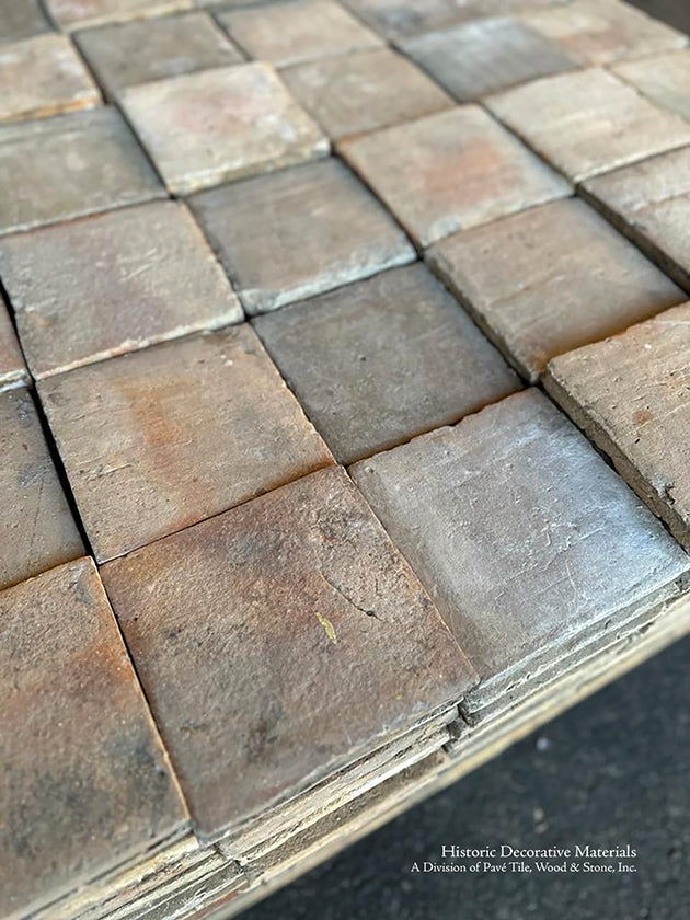 An earth tone mix with gray colors of French reclaimed terra cotta tiles makes for a beautiful kitchen floor.