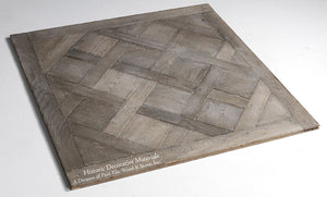 Aged French oak blocks composed into panels and held together by a tongue and groove design is a traditional method of creating a parquet de Versailles panel.