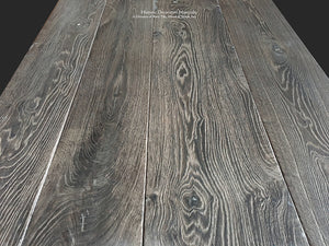 Wide-plank reclaimed French oak flooring in charcoal and oak patina enriches historic interiors.