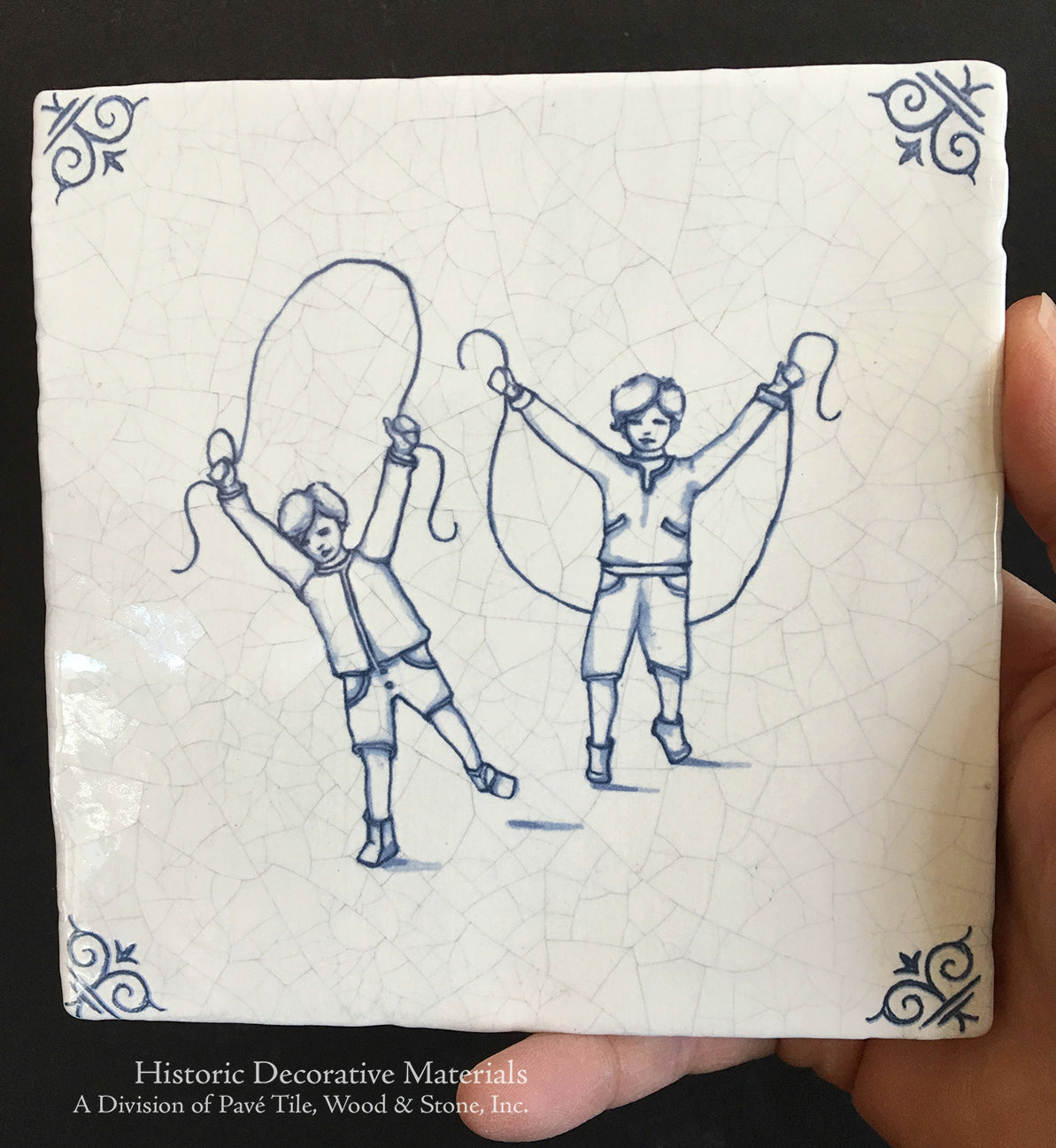 Hand painted blue and white Antique Delft tiles of two boys jumping rope is a classic Delft motif.